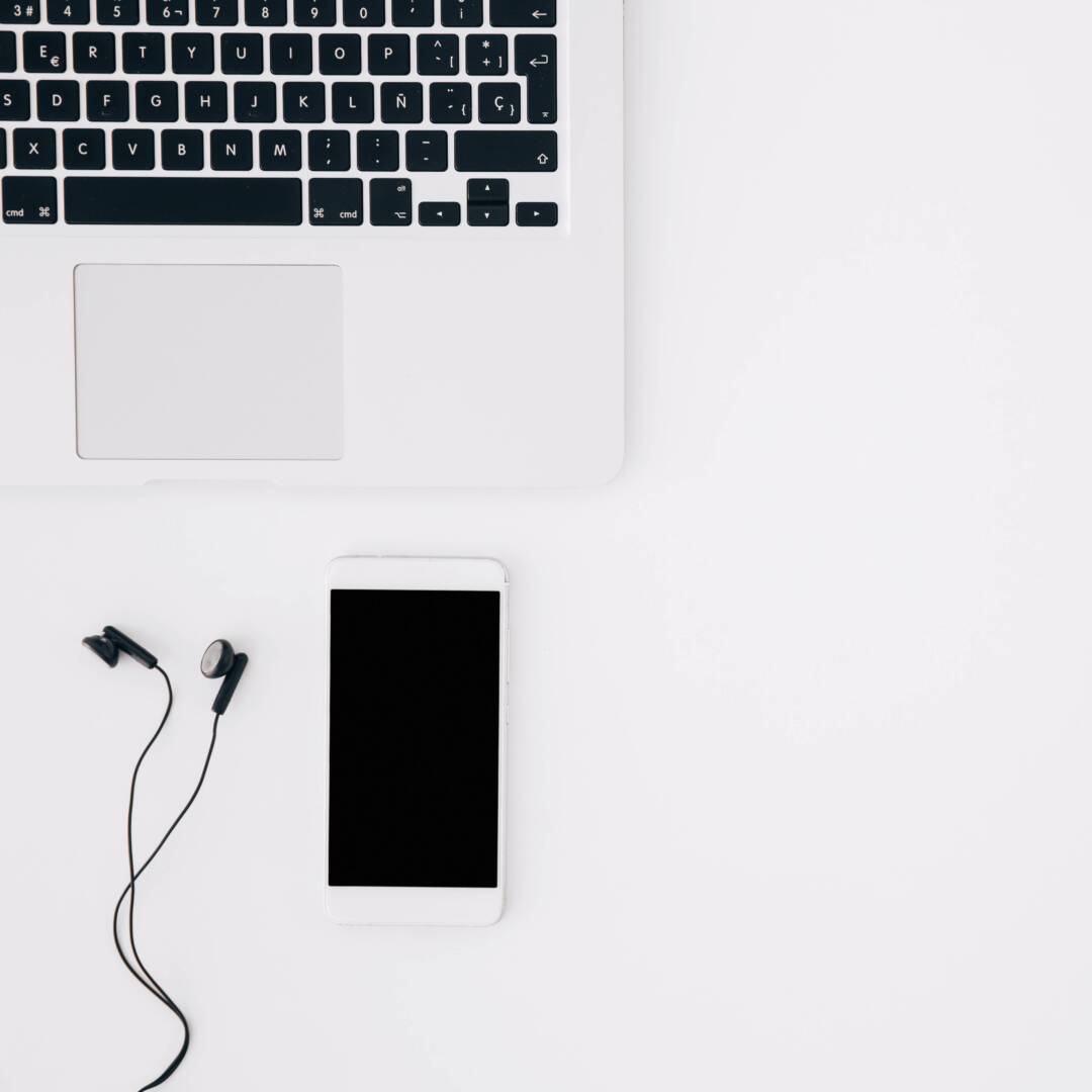 smartphone-earphone-with-open-laptop-isolated-white-backdrop